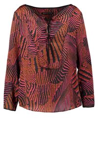 Blouse manches longues avec des rayures abstraites rose et marron style zèbre, un col rond et un petit détail de lien à l'avant.
