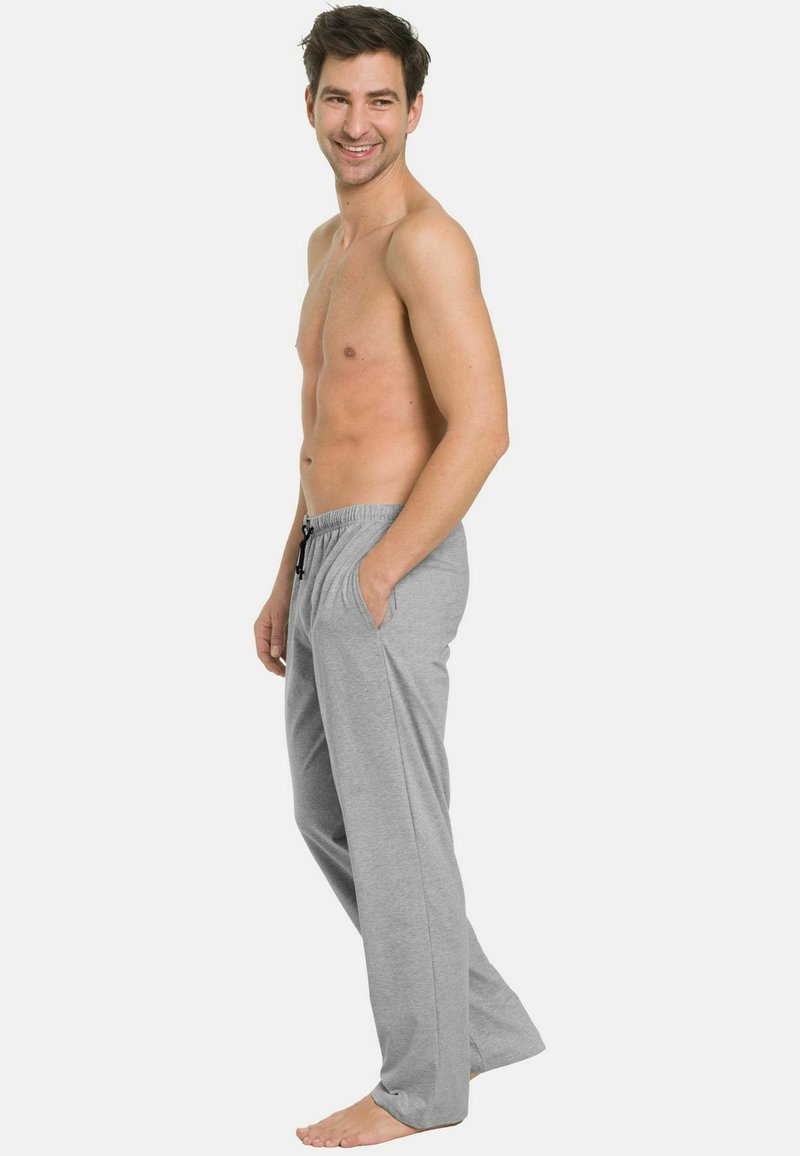 Graue Loungehosen aus weichem Stoff, mit einem elastischen Bund und Kordelzug, seitlichen Taschen und einer lockeren Passform.