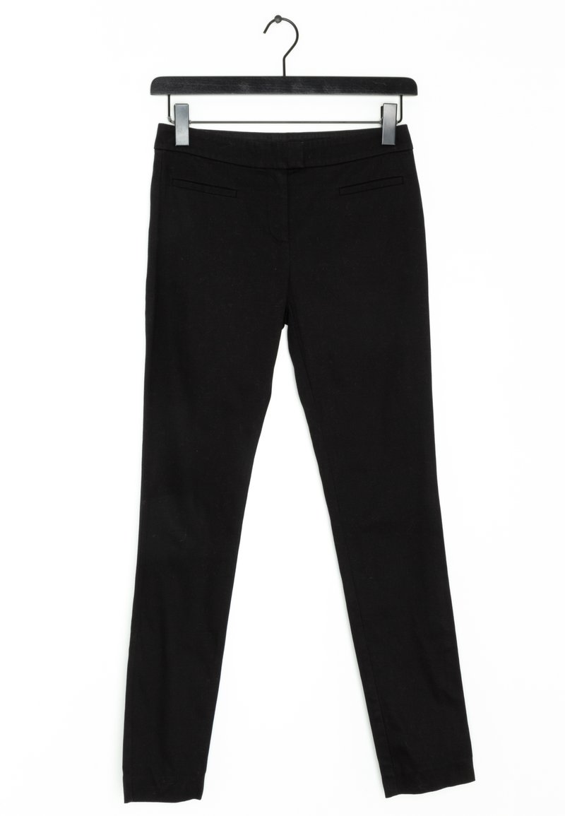 Black trousers hanging on a black hanger, featuring a smooth fabric, slim fit, two front pockets, and no visible fastenings.
