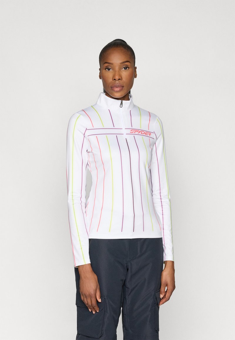 White long-sleeve top with multicolored vertical stripes in pink, yellow, and purple. Features a zippered collar and a logo on the chest.