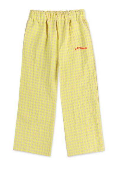 Yellow gingham-patterned wide-leg pants with an elastic waistband and red embroidered text on the side. Made from lightweight fabric.