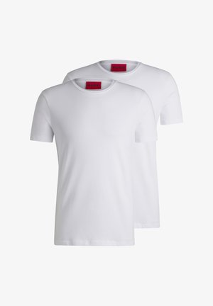 Two plain white crew neck t-shirts, short sleeve, made of cotton, featuring a red HUGO tag at the neckline. No patterns or graphics.