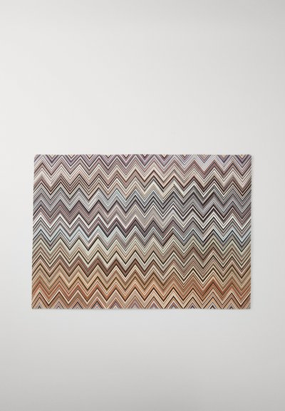 Flerfarget zigzag-mønstrete teppe med en gradient fra mørkebrunt til lysere nyanser, med glatt, flat tekstur og rektangulær form.