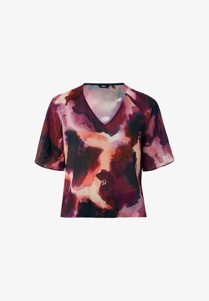 Blouse à manches courtes en tissu fluide dans des couleurs vives de violet, rouge et noir, dotée d'un col en V et d'un doux motif floral abstrait.