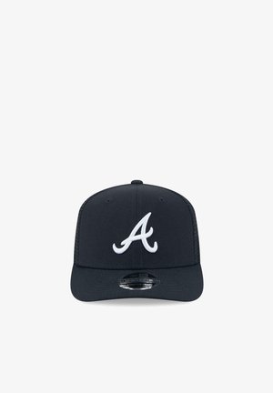 Black baseball cap with white stylized letter "A" on front and a flat visor, displayed against a white background.