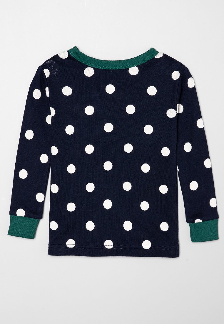 Chemise à manches longues bleu marine avec des pois blancs, dotée d'un col côtelé vert et de poignets de manches. Fabriquée en tissu doux et extensible.