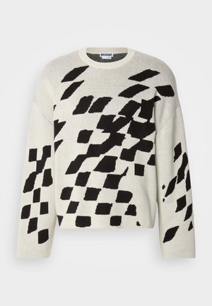 Cream sweater with black geometric patterns, round neckline, long sleeves, and soft knit texture. Casual design suitable for layering.