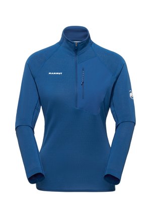 Maglia sportiva a maniche lunghe blu con cerniera a un quarto, tasca con cerniera sul petto a sinistra, logo Mammut sul petto destro e sulla manica sinistra.