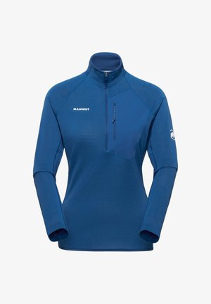 Maglia sportiva a maniche lunghe blu con cerniera a un quarto, tasca con cerniera sul petto a sinistra, logo Mammut sul petto destro e sulla manica sinistra.