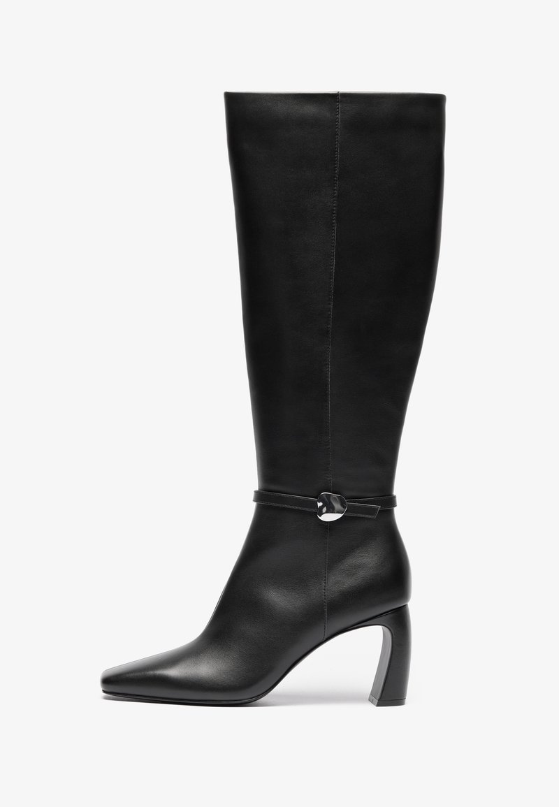 Black leather knee-high boots with a pointed toe and a chunky heel. Features a strap with a circular accent detail at the ankle.