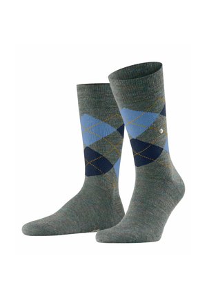Chaussettes légères en vert, ornées d'un motif en losanges bleu et marine, rehaussées de coutures jaunes. Texture tricotée et longueur mi-mollet.