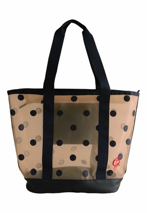 Sac fourre-tout beige transparent avec des pois noirs, des poignées noires, une base noire et un petit logo rouge dans le coin inférieur droit.