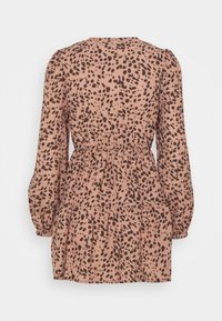 Růžové šaty košilového stylu s černým tečkovaným vzorem, s balónovými rukávy, upnutým pasem a vrstevnatou sukní. Měkká texturovaná látka.