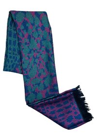 Écharpe tissée présentant un motif complexe en teal et magenta, avec des extrémités à franges et une texture douce. Forme rectangulaire.