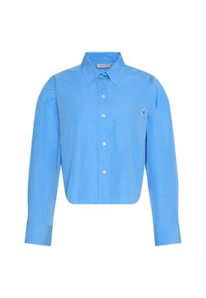 Ανοιχτό μπλε πουκάμισο με μακριά μανίκια, κουμπιά, μυτερό γιακά, τσέπη μπροστά και διακριτικό λογότυπο στο πάνω δεξί μέρος της τσέπης.