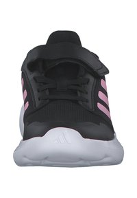 Czarne buty sportowe z różowymi akcentami, z teksturowaną górą, sznurówkami oraz zapięciem na rzep, i miękką białą podeszwą.