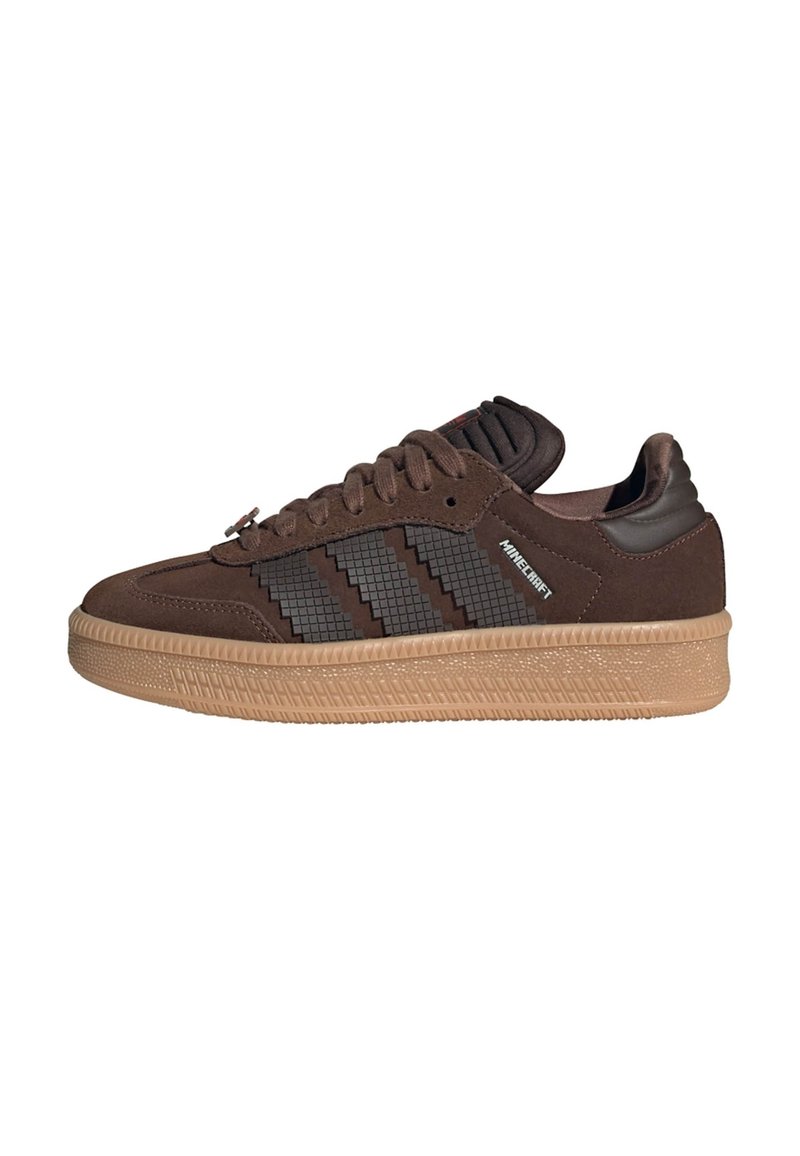 Braune Wildledersneakers mit einem strukturierten, dunkelbraunen Seitenstreifen und einer hellbraunen Gummisohle. Mit einem gepolsterten Schaft und flachen Schnürsenkeln.