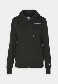 Felpa nera con zip e cappuccio regolabile, due tasche frontali e logo "Champion" bianco sul petto. Realizzata in un morbido tessuto testurizzato.