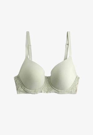 Reggiseno imbottito beige con spalline regolabili e dettagli in pizzo lungo la fascia inferiore, mostrato su uno sfondo bianco.