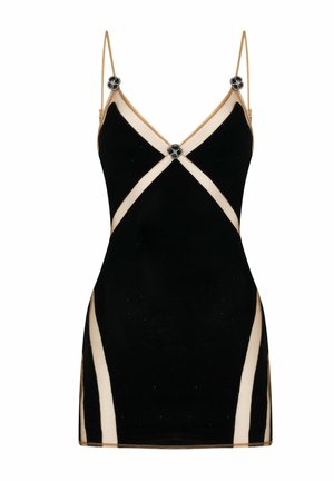 Mini robe noire avec bordure beige, fines bretelles, et boutons décoratifs en forme de fleur noirs et argentés au niveau de la poitrine et des épaules.