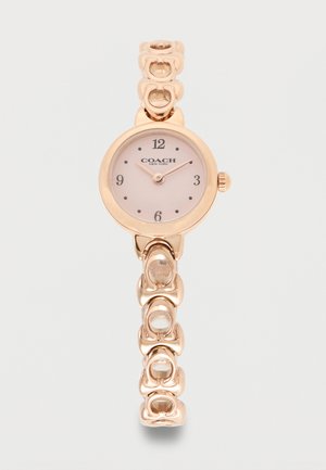 Rožnato zlata zapestna ura Coach z okroglim številčnico, minimalistično številčnico, številčnimi oznakami 12, 3, 6, 9 in povezano dekorativno verižico zapestnico.