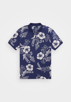 Polo bleu marine avec motifs floraux et feuilles blancs, manches courtes et col à trois boutons.