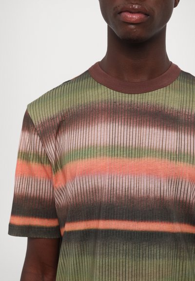 Short-sleeve t-shirt made of soft fabric with a ribbed texture, featuring a multicolored stripe pattern in green, brown, and coral.
