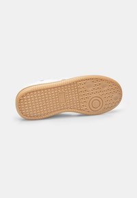 Rubber shoe sole with a textured surface, featuring a light brown color and circular pattern details. The brand name "NORTH STAR" is embossed.