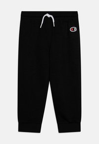 Black sweatpants made of soft fabric with an elastic waistband, adjustable white drawstring, and cuffed ankles. Features a small logo patch.