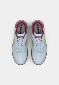 Light blue sneakers with green accents and a maroon collar. Features white laces, a textured suede finish, and a rubber sole.
