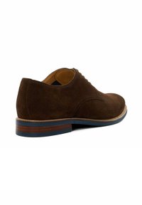 Brown suede shoe with a rounded toe, contrasting light stitching, and a stacked wooden heel accentuated by a blue rubber insert.