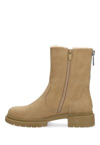 Tan läderankelstövel med dubbla siddragkedjor, texturerad yta, mjukt foder och en robust gummisula.