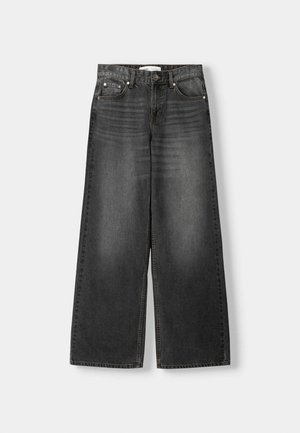 Jeans in denim nero a gamba larga con vita alta, dotati di cinque tasche, accessori metallici e schemi di scolorimento delicati sul tessuto.