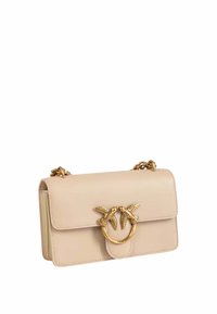 Borsa a tracolla in pelle beige con design strutturato, dotata di un accento decorativo a forma di uccello in oro e una tracolla a catena. Compatta ed elegante.