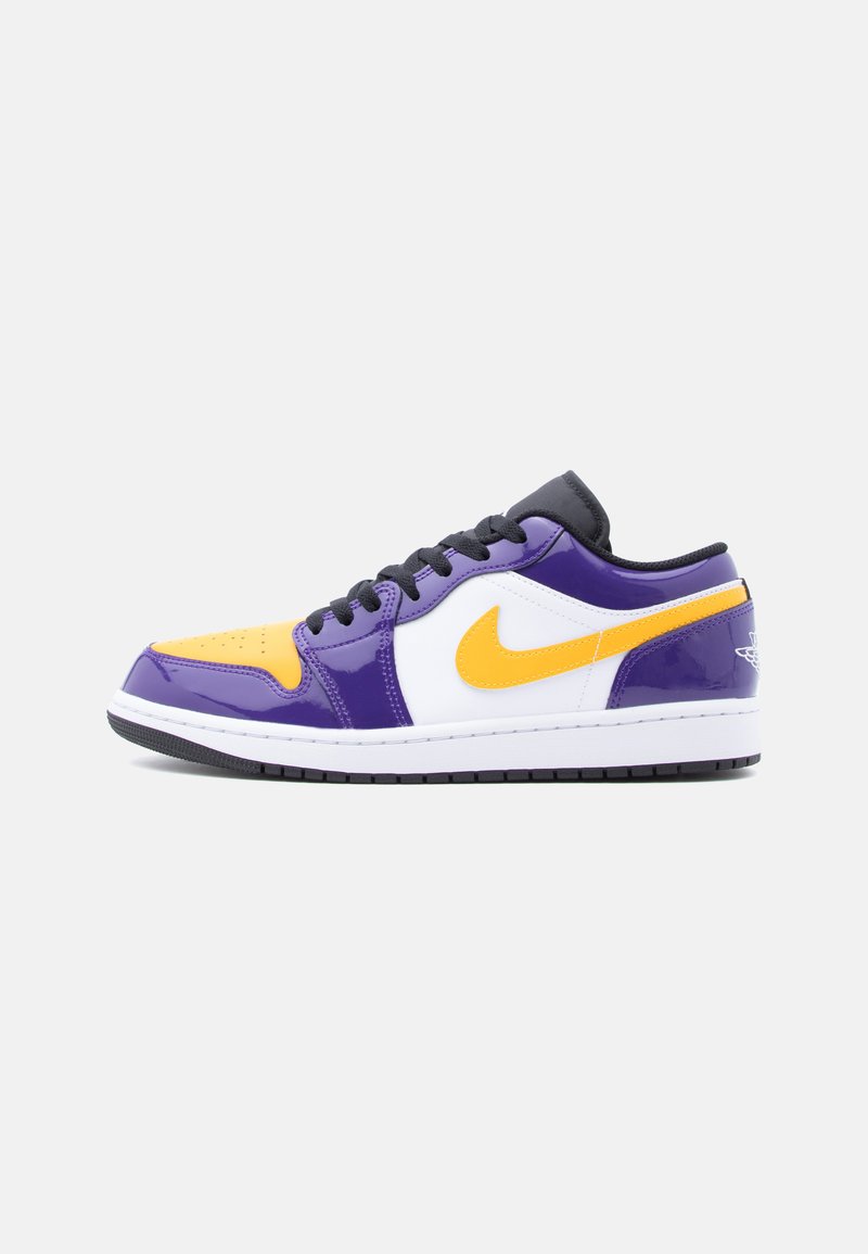 Nike shoes featuring a glossy purple, yellow, and white colorway, with a low-top design and black laces. Iconic swoosh and textured accents.