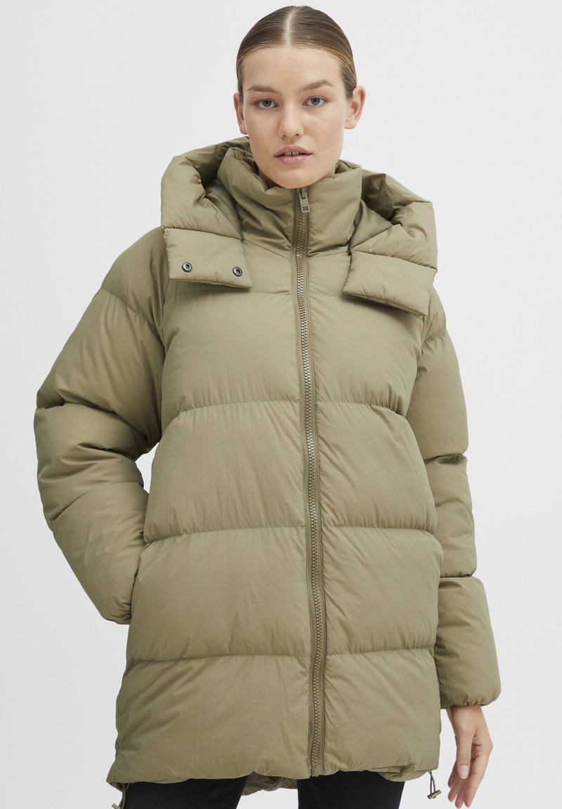 Olive green puffer jacket with a high collar, horizontal quilting, and a front zipper. Features a detachable hood and adjustable hem.