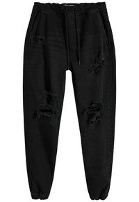 Svarta joggingbyxor med elastisk midja och muddar, med flera slitna och brända områden på framsidan av båda benen.