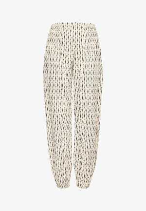 Witte broek met zwarte verticale lijnen en abstracte patronen. Voorzien van een elastische tailleband en taps toelopende pijpen. Lichtgewicht, ademende stof.