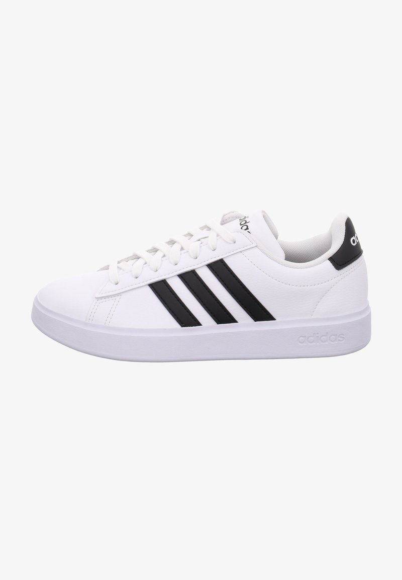 White sneaker with three black stripes, smooth synthetic material, rounded toe, and a white rubber sole. Brand logo on the heel.