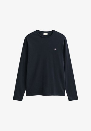 Langærmet navyblå T-shirt i bomuld med rund halsudskæring og lille broderet logo på venstre bryst. Glat tekstur, afslappet pasform.