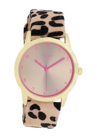 Montre dorée avec un bracelet en suède imprimé léopard beige et noir, index horaires roses et un cadran métallique brossé. Design de boîtier rond.