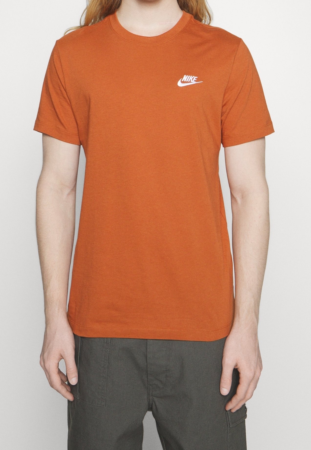 brown and orange nike shirt