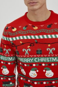 Roter Weihnachtspulli mit festlichen Mustern, darunter Schneemänner, Zuckerstangen, Geschenke und bunte Ornamente mit grünen und weißen Akzenten.