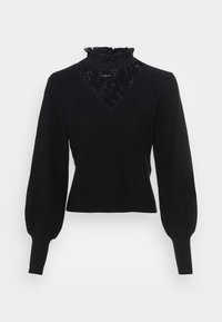 Pull noir côtelé avec un empiècement en dentelle, un col montant volanté et des manches longues bouffantes avec des poignets ajustés. Ourlet en forme de V.