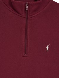 Bordeaux kwart rits sweatshirt van zacht materiaal, met een subtiele geborduurde witte logo van een golfer. Glad oppervlak met gestikte accenten.