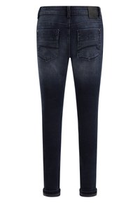 Tmavě modré skinny džíny s tapered střihem, které mají dvě zadní kapsy a ohrnutý lem. Jemná textura s mírným efektem vyblednutí.