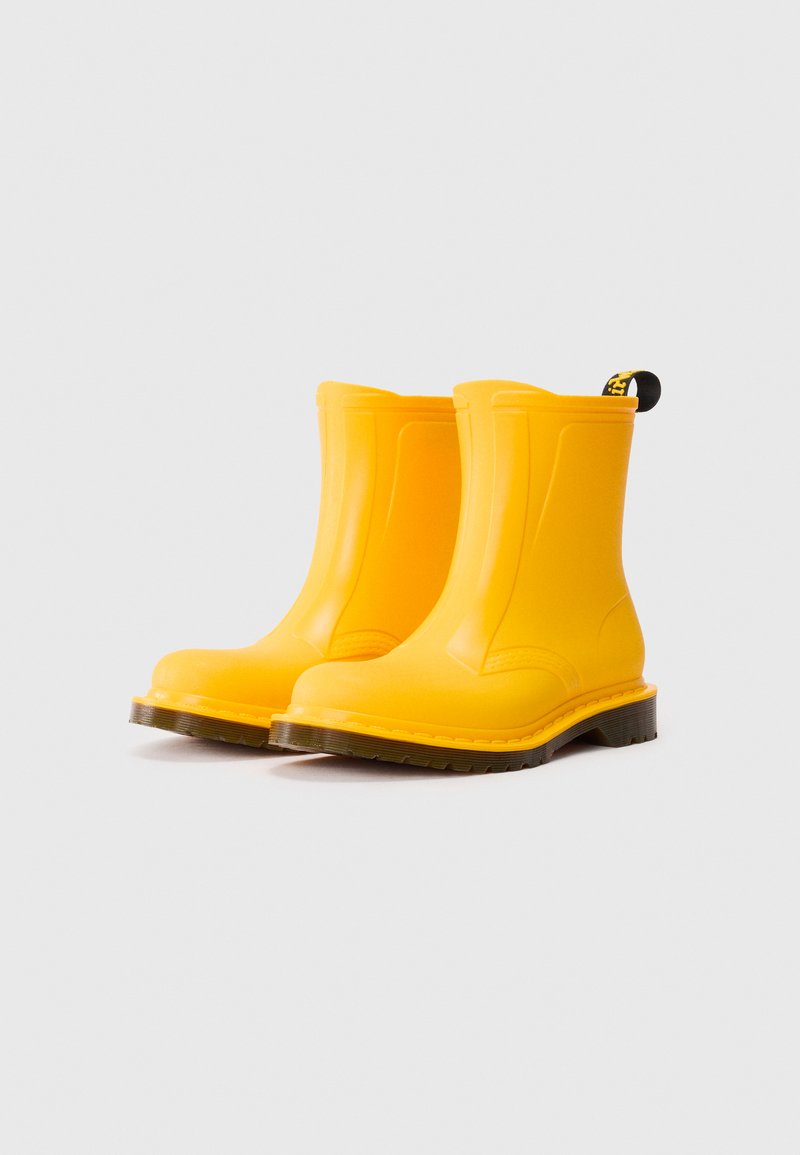 Bright yellow mid-calf rubber boots with dark textured soles and black pull tabs against a plain white background.