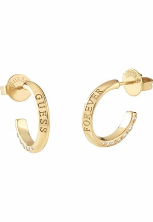 Gold hoop earrings with "GUESS" engraved on the left and "FOREVER" on the right, each featuring small embedded clear stones.