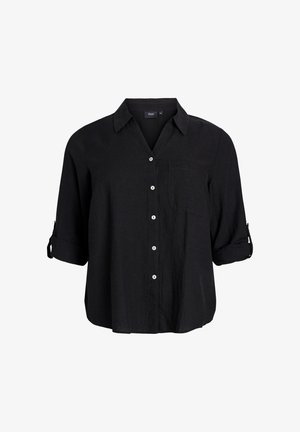 Camicia nera in lino con colletto, tasca frontale e maniche arrotolabili. Sei bottoni bianchi lungo la parte anteriore per la chiusura.