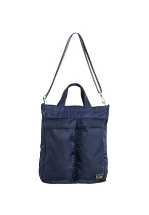 Bolsa tote de nylon azul marino con dos bolsillos delanteros, asas cortas y una correa larga para el hombro desmontable.